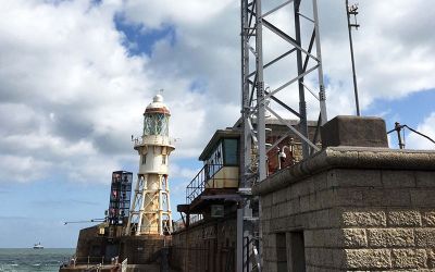 Radar tower on harbour wall