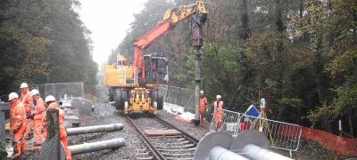 Installing screw piles on rail