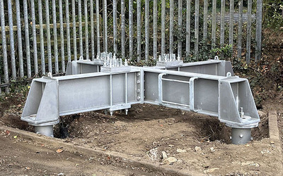 Bridging old concrete foundation for tower with screw piles and grillage.