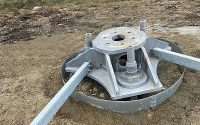 Bridging old concrete foundation for tower with screw piles and grillage.